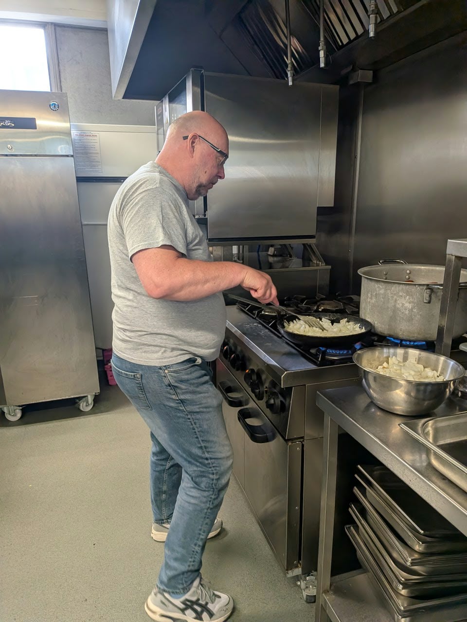 Pete cooking onions in the kitchen of the YMCA North Staffs ready to serve at the Big Day Out